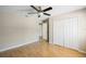 Bedroom with light hardwood flooring, closet with sliding doors, and overhead lighting at 1171 Clays Trl, Oldsmar, FL 34677