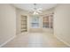 Bright dining area featuring built-in shelves, tiled floor, and a ceiling fan for added comfort at 1171 Clays Trl, Oldsmar, FL 34677