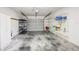 Spacious garage with ample storage shelving, concrete floor, and an automatic garage door opener at 1171 Clays Trl, Oldsmar, FL 34677