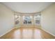 Bright living room featuring beautiful wood floors and three large windows offering lots of natural light at 1171 Clays Trl, Oldsmar, FL 34677