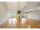 Spacious living room with hardwood floors, a fireplace, and sliding glass doors that bring in plenty of natural light at 1171 Clays Trl, Oldsmar, FL 34677