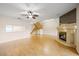 Bright living room featuring a staircase, hardwood floors, and a fireplace, perfect for entertaining guests at 1171 Clays Trl, Oldsmar, FL 34677