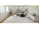 Staged living room showcasing a stylish sofa, decor, and lots of natural light from the windows at 1171 Clays Trl, Oldsmar, FL 34677