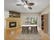 Bright living room with hardwood floors, a fireplace, and dining table for relaxation and entertainment at 1171 Clays Trl, Oldsmar, FL 34677