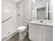 Bathroom featuring a toilet, a shower with safety rails and a vanity with a sink at 3403 30Th E Ln, Bradenton, FL 34208