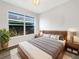 A modern bedroom with light wood furnishings, large window, and neutral color palette offers a serene retreat at 3403 30Th E Ln, Bradenton, FL 34208