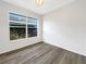 Minimalist bedroom featuring modern flooring, a large window, and neutral wall color at 3403 30Th E Ln, Bradenton, FL 34208