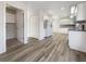 Open kitchen with white cabinets, appliances, and wood-look flooring, offering plenty of space and storage at 3403 30Th E Ln, Bradenton, FL 34208