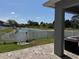 Scenic backyard overlooking a pond, enclosed with a white picket fence at 3721 Heron Island Dr, New Port Richey, FL 34655