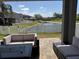 Beautiful backyard with lake view, outdoor seating area and manicured lawn at 3721 Heron Island Dr, New Port Richey, FL 34655