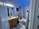 Bathroom with a single vanity, tiled floors, and a bathtub-shower combination with themed decorations at 3721 Heron Island Dr, New Port Richey, FL 34655