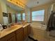 Bathroom boasting double sinks, soaking tub, and a separate shower stall at 3721 Heron Island Dr, New Port Richey, FL 34655