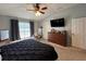 Bedroom with large window, ceiling fan, and ensuite bathroom access at 3721 Heron Island Dr, New Port Richey, FL 34655