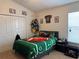 Football-themed bedroom featuring a themed bedspread, ample storage, and playful decor at 3721 Heron Island Dr, New Port Richey, FL 34655