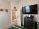 Bedroom featuring football themed decorations, a tv, and a view into the bathroom at 3721 Heron Island Dr, New Port Richey, FL 34655