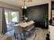 Elegant dining area with an accent wall, and modern furnishings, creating a perfect setting for Gathering meals at 3721 Heron Island Dr, New Port Richey, FL 34655