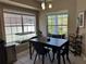 Cozy dining area with natural lighting, modern furniture, and a view to the front yard at 3721 Heron Island Dr, New Port Richey, FL 34655