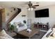 Comfortable living room with a ceiling fan, large TV, and neutral-toned furniture at 3721 Heron Island Dr, New Port Richey, FL 34655