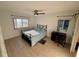 Bright bedroom with wood-look tile, fan, a desk, and two windows providing natural light at 721 83Rd N Ave # 108, St Petersburg, FL 33702
