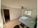 Bright bedroom with wood-look tile, fan, a desk, and a window providing natural light at 721 83Rd N Ave # 108, St Petersburg, FL 33702