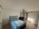 Well-lit bedroom with tile floors, ceiling fan, work space, and closet with sliding door at 721 83Rd N Ave # 108, St Petersburg, FL 33702