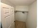 Walk-in closet with hanging racks and tile floors, providing ample storage for clothing and accessories at 721 83Rd N Ave # 108, St Petersburg, FL 33702