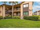 Inviting condo building with manicured lawn and lush landscaping in a well-maintained community at 721 83Rd N Ave # 108, St Petersburg, FL 33702