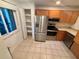 Modern kitchen with stainless steel appliances, ample cabinet space, and a window view at 721 83Rd N Ave # 108, St Petersburg, FL 33702