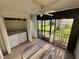 Bright lanai with ceiling fan, tiled floor, and sliding glass doors that lead to a green outdoor space at 721 83Rd N Ave # 108, St Petersburg, FL 33702