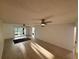 Bright living room featuring tile flooring, a ceiling fan, and sliding glass doors to the lanai at 721 83Rd N Ave # 108, St Petersburg, FL 33702