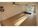 Spacious living room with modern floors, decorative wall art, and a sliding glass door entrance to the lanai at 721 83Rd N Ave # 108, St Petersburg, FL 33702