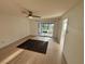 Open-concept living room with modern flooring, a ceiling fan, and sliding glass doors to the lanai at 721 83Rd N Ave # 108, St Petersburg, FL 33702