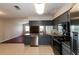 Bright kitchen with stainless steel appliances, granite countertops, open to a brick fireplace at 1117 Mook St, Brandon, FL 33510
