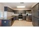 Well-appointed kitchen featuring stainless steel appliances, granite countertops, and generous storage at 1117 Mook St, Brandon, FL 33510