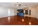 Open-concept living area with hardwood floors, leading to kitchen and bright sliding glass doors at 1117 Mook St, Brandon, FL 33510