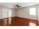 Open room showcasing wood floors, a ceiling fan, and access to the outdoors at 1117 Mook St, Brandon, FL 33510