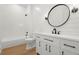 Modern bathroom with a large mirror, a vanity, and a shower and tub combination at 4115 N Central Ave, Tampa, FL 33603