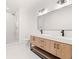 Bright bathroom featuring double vanity with modern fixtures and a glass-enclosed shower at 4115 N Central Ave, Tampa, FL 33603