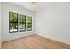 Bright, empty bedroom with large windows and hardwood floors at 4115 N Central Ave, Tampa, FL 33603