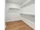 Walk-in closet offering ample storage with white shelving and wood-look flooring at 4115 N Central Ave, Tampa, FL 33603