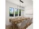 Elegant dining room with modern lighting, large windows, and seating for six at 4115 N Central Ave, Tampa, FL 33603