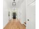 Bright entryway with hardwood floors, modern light fixtures, and white walls at 4115 N Central Ave, Tampa, FL 33603