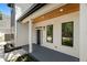 Inviting front porch with wood ceiling, white columns, and dark-framed windows and door at 4115 N Central Ave, Tampa, FL 33603