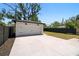 Spacious detached white garage with black accents and a large concrete parking pad at 4115 N Central Ave, Tampa, FL 33603