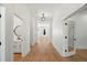 Hallway with hardwood floors, white walls, and doorway views into other rooms at 4115 N Central Ave, Tampa, FL 33603