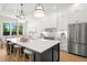 Modern kitchen with stainless steel appliances, island with seating, and bright, open floor plan at 4115 N Central Ave, Tampa, FL 33603