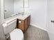Cozy bathroom with a single sink vanity and a framed mirror at 6902 Lakeview Ct, Tampa, FL 33634