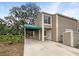 Charming two-story home featuring a covered carport and well-maintained landscaping at 6902 Lakeview Ct, Tampa, FL 33634