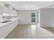 Eat-in kitchen with white cabinets and long breakfast bar for easy entertaining and dining at 6902 Lakeview Ct, Tampa, FL 33634