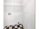 Small utility room with checkerboard flooring and wire shelving for optimal storage at 6902 Lakeview Ct, Tampa, FL 33634